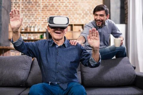Cheerful elderly man using VR device Stock-Fotos
