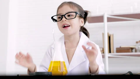 Cheerful elementary kid laughing in laboratory with white coat uniform, fun.. Stock-Footage 243559896