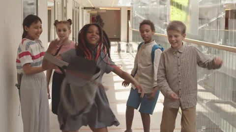 Cheerful Elementary Kids Having Fun and Dancing in School Corridor Stock Footage 183759223