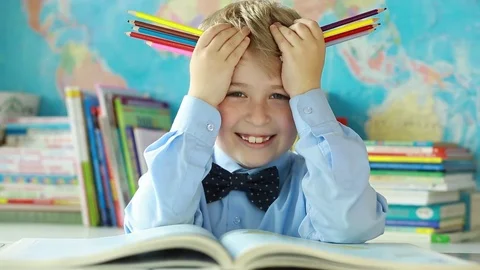  Cheerful elementary school student with  pencils. Stock Footage 77747676