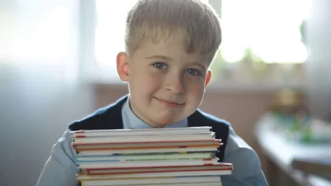 Cheerful elementary school student with textbooks Stock Footage 69772963