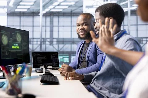 Cheerful engineer in data center getting access granted notification Stock Photos