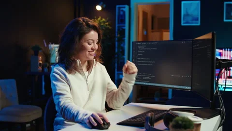 Cheerful engineer excited after finding no errors in code Stock Footage 283689818