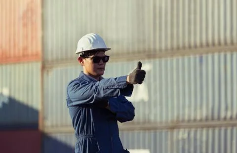 Cheerful engineer man in hard hat with giving thumbs up as sign of success Фото