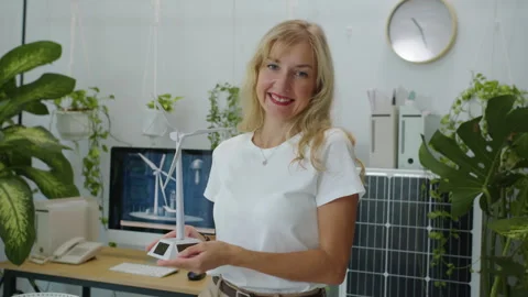 Cheerful Engineer Posing for Camera with Model of Wind Turbine Stock Footage 276883284