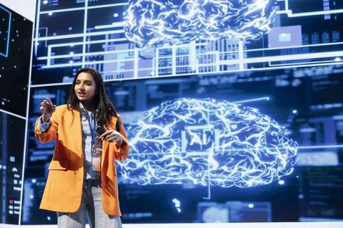 Cheerful engineer talking at AI tech summit event gathering professionals Stock Photos