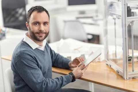 Cheerful engineer using the tablet during break at work Stock Photos