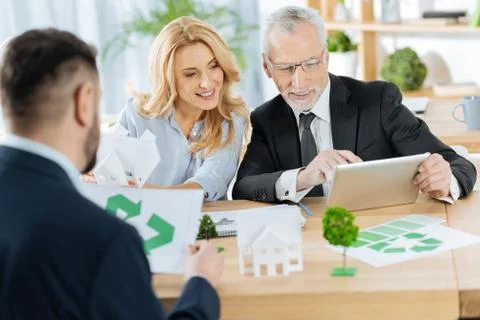 Cheerful engineers looking at the tablet and smiling while working Foto stock