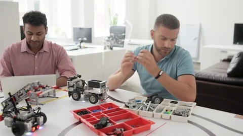 Cheerful engineers working together Stock Footage