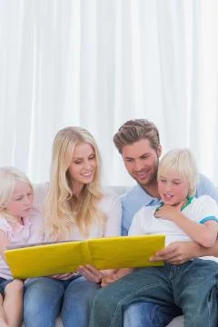Cheerful family reading a story together Stock Photos