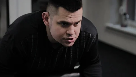 Cheerful fat man performs a wrong exercise in the gym. For the first time in a Stock Footage 105942775