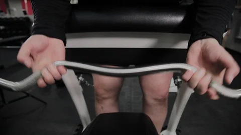 Cheerful fat man performs a wrong exercise in the gym. For the first time in a Stock Footage 105942861