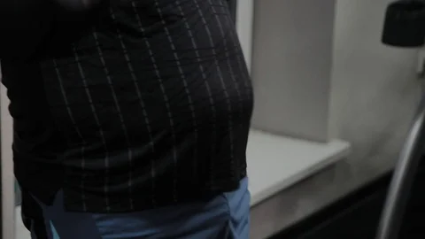 Cheerful fat man performs a wrong exercise in the gym. For the first time in a Stock Footage 105943080