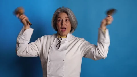 Cheerful female chef dancing and playing with wooden cooking utensils Stock Footage 341336178