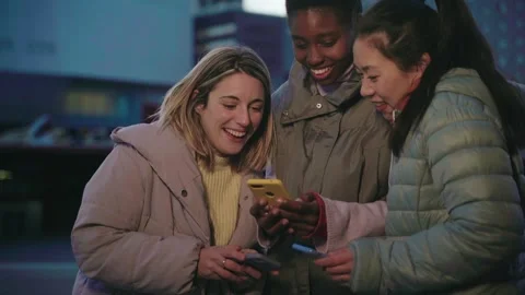 Cheerful female friends using cell phones. Technology addicted concept Stock Footage 292898207