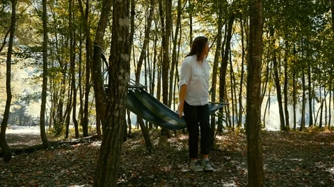 Cheerful female lying down in hammock and resting in nature Stock Footage 100256038