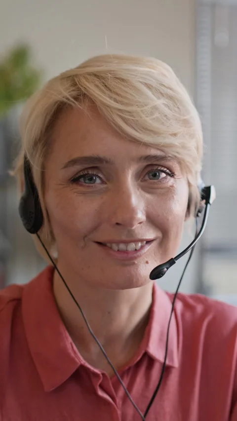 Cheerful Female Operator in Headset Working in Call Center, Vertical Portrait 스톡 동영상 335748565
