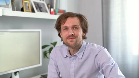 Cheerful freelance male software developer or IT support working at office, 4k Stock Footage 229788484