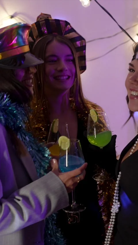 Cheerful friends dancing and drinking cocktails at new year's eve party Stock Footage 324465972