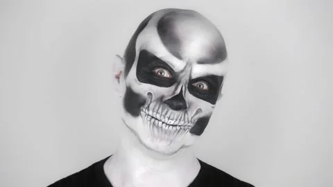 Cheerful funny man in skeleton make-up for Halloween smiles at the camera Stock-Footage 139289463