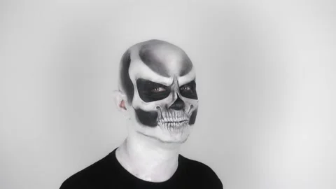 Cheerful funny man in skeleton makeup for Halloween smiles and dances Vídeo Stock 139287764