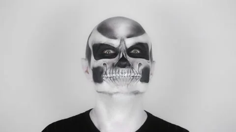 Cheerful funny man in skeleton makeup for Halloween smiles and dances Stockbeeldmateriaal 139288063