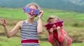 Cheerful girl in big glasses in the shape of stars looks at the camera and dance HD Footage