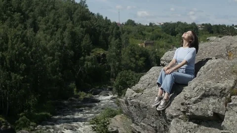 Cheerful girl posing on boulder Stock Footage 78568152