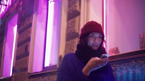 Cheerful girl texting using app on smart phone at night in city. Stock Footage 83072778