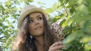 Cheerful Girl throws an apple into the camera Stock Footage 85487405