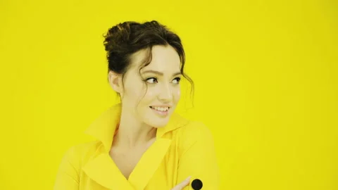 Cheerful girl in yellow posing on camera. Stock Footage 115565242