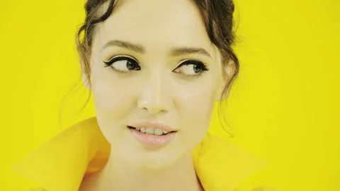 Cheerful girl in yellow posing on camera. Stock Footage 115565572