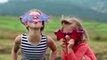 Cheerful girls in big glasses in the shape of stars looks at the camera HD Footage
