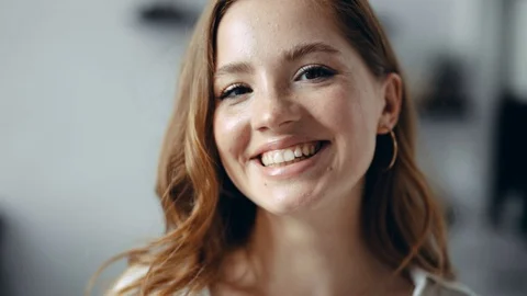 Cheerful good looking young redhead woman with freckles in the apartment looks Stock Footage 115509272