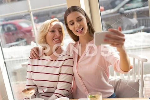Cheerful granny and girl taking selfies Stock Photos