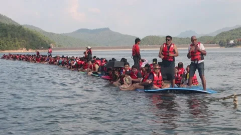 Cheerful group of Asian tourists dancing and having fun on floating raft Stock Footage 343229166