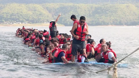 Cheerful group of Asian tourists dancing and having fun on floating raft Stock Footage 344157702