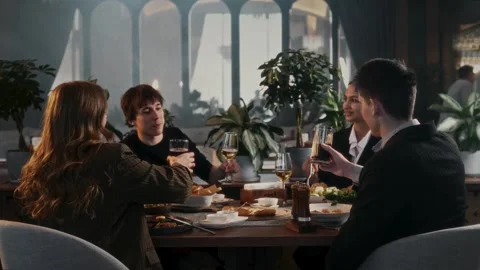 Cheerful group of friends are having a pleasant evening at a table Stock Footage 314577469