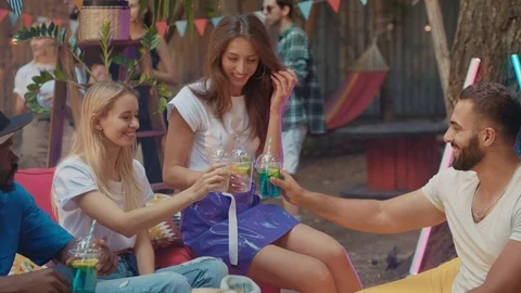 Cheerful group of friends having nice time drinking cheering drinks relaxing on Stock Footage 114928094