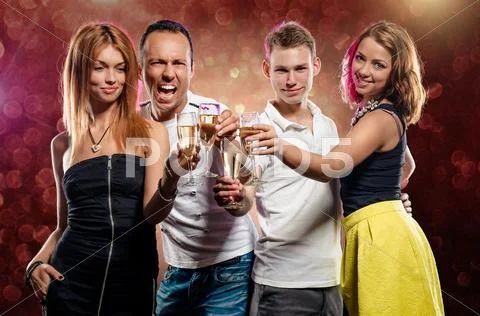 Cheerful group of young people with glasses of sparkling champagne Stock Photos