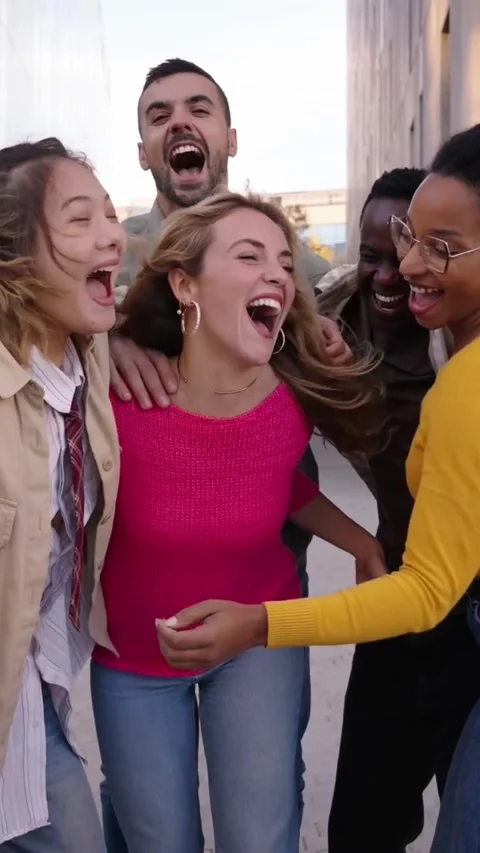 Cheerful group of young people hugging together her blonde woman friend happily Stock Footage 273000788