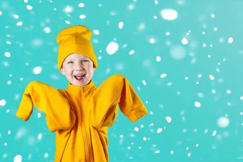 A cheerful guy in a bright yellow jacket and hat enthusiastically rejoices on Photos