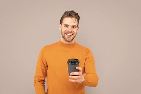 Cheerful guy at coffee break in studio. guy at coffee break hold cup. photo of Stock Photos