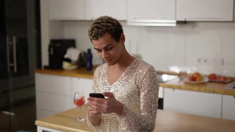 Cheerful guy in fancy dress using mobile phone at home kitchen Stock Footage 170181835