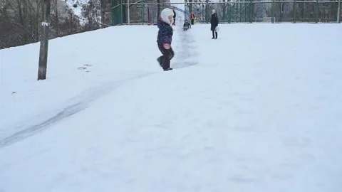 Cheerful guy goes down a snowy hill. Slow motion 01.10.2020 Ukraine, Kiev Stock Footage 126641213