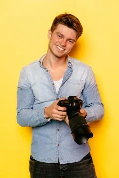 Cheerful guy holding digital camera Stock Photos