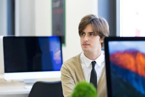 Cheerful guy sitting in front of desktop computer 写真素材