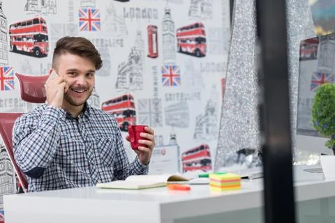 Cheerful guy sitting in front of desktop computer 스톡 사진