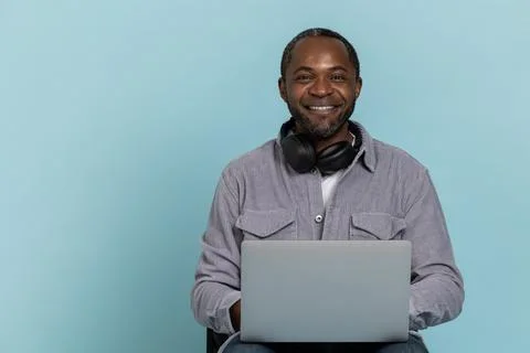 Cheerful guy working on laptop remote job. 写真素材