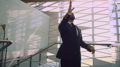 Cheerful handsome bearded man in pilot uniform actively makes winning gestures Stock Footage 109148550